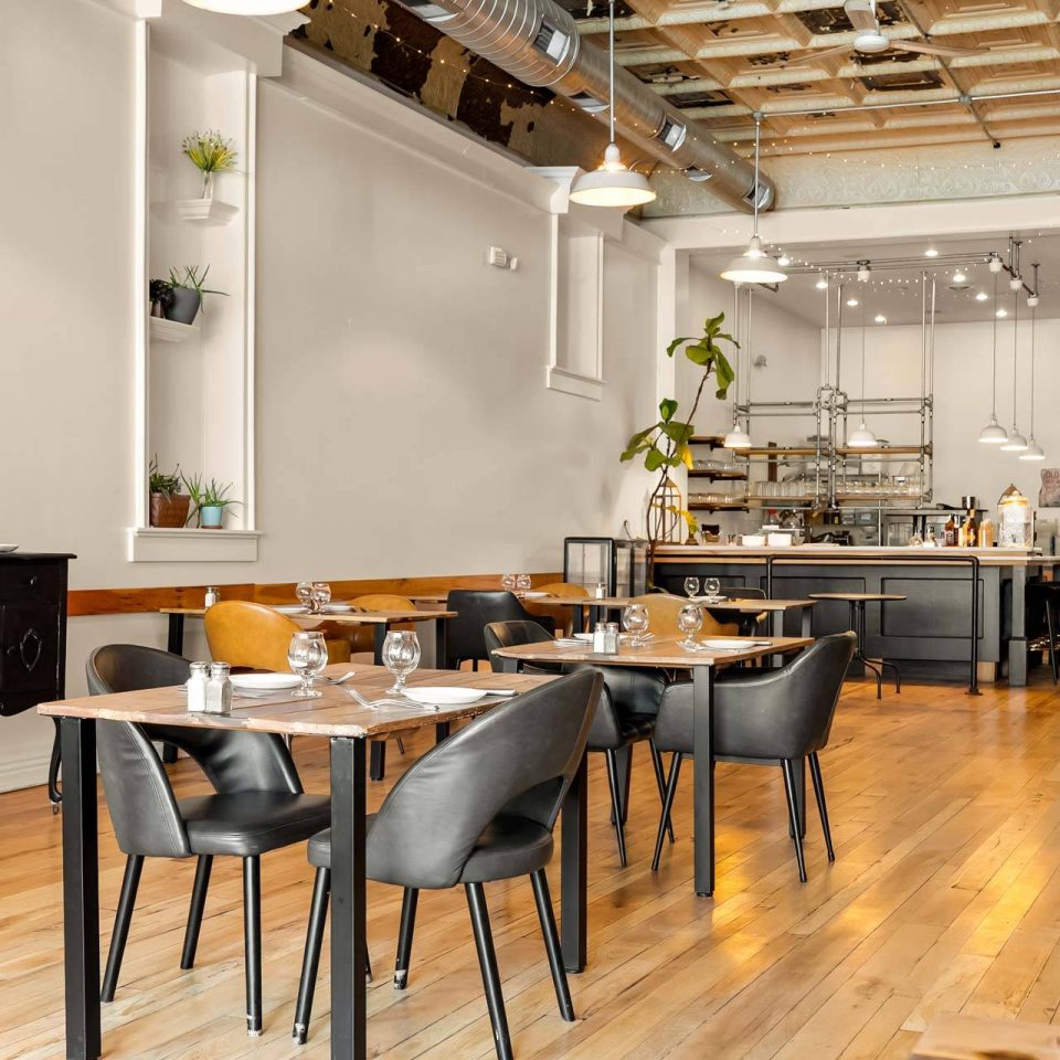 The Vic dining room with leather chairs and open kitchen