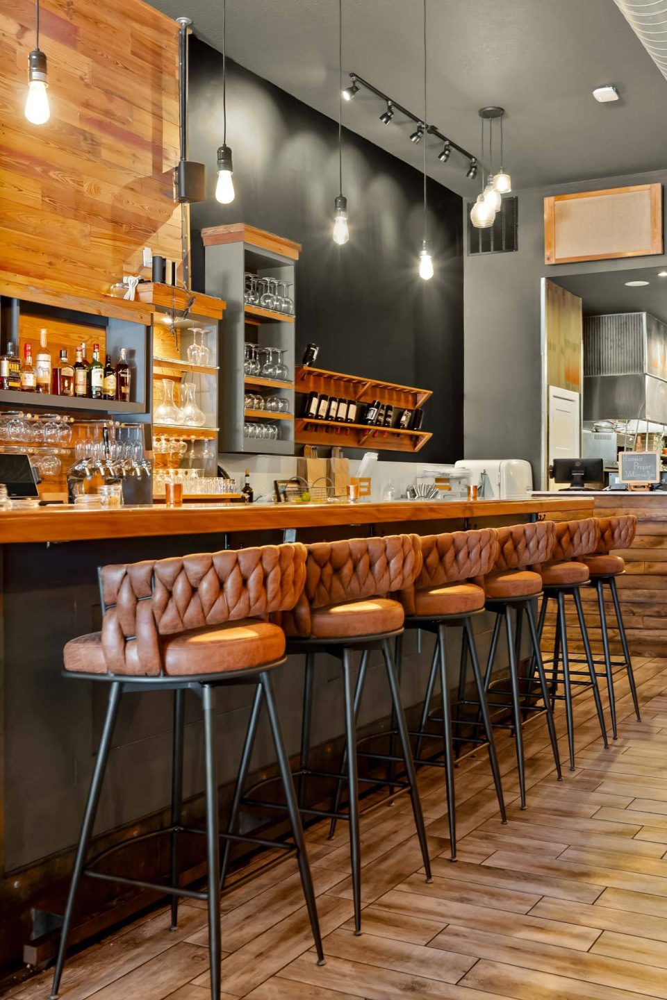 Main bar with woven leather stools and pendant lighting