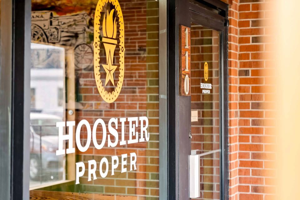 Hoosier Proper front door with torch logo signage