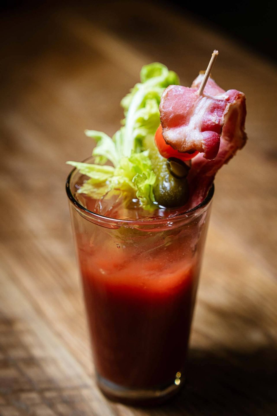 House Bloody Mary with bacon, celery, and pickle garnish