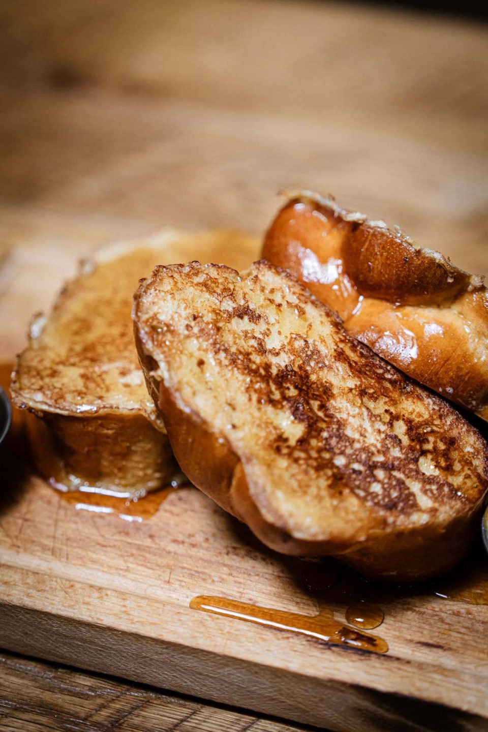 Golden challah French toast drizzled with syrup