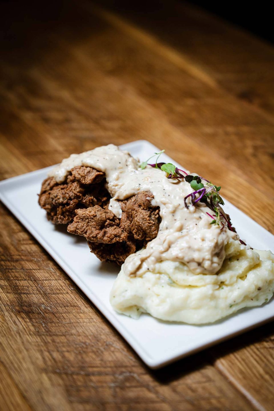 Chicken fried steak with peppered cream gravy and mashed potatoes