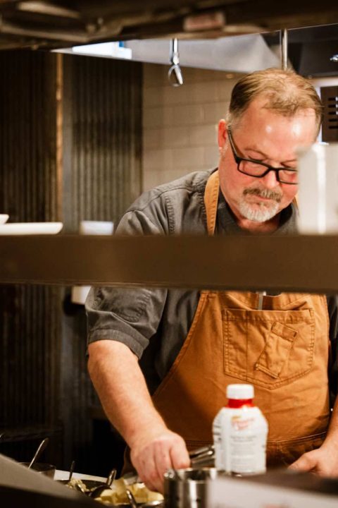 Executive chef plating on the kitchen line