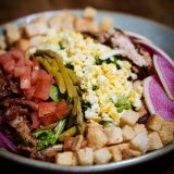 Cobb salad with bacon, egg, tomato, and blue cheese
