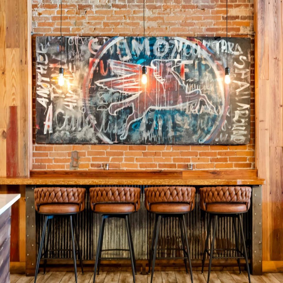 Bar seating with brick wall and mural