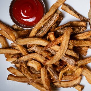 Hand-cut fries with a side of ketchup