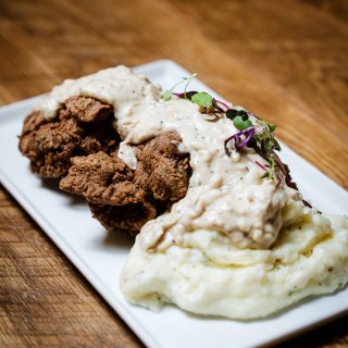 Chicken fried steak with cream gravy and mashed potatoes